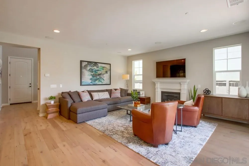 15559 Tanner Ridge Road San Diego, CA 92127 - Photo 3 of 25 a living room with fireplace furniture and a flat screen tv