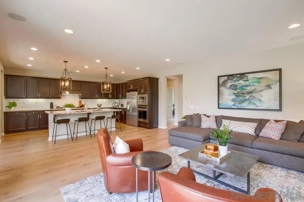 15559 Tanner Ridge Road San Diego, CA 92127 - Photo 4 of 25 a living room with stainless steel appliances kitchen island furniture and a view of kitchen
