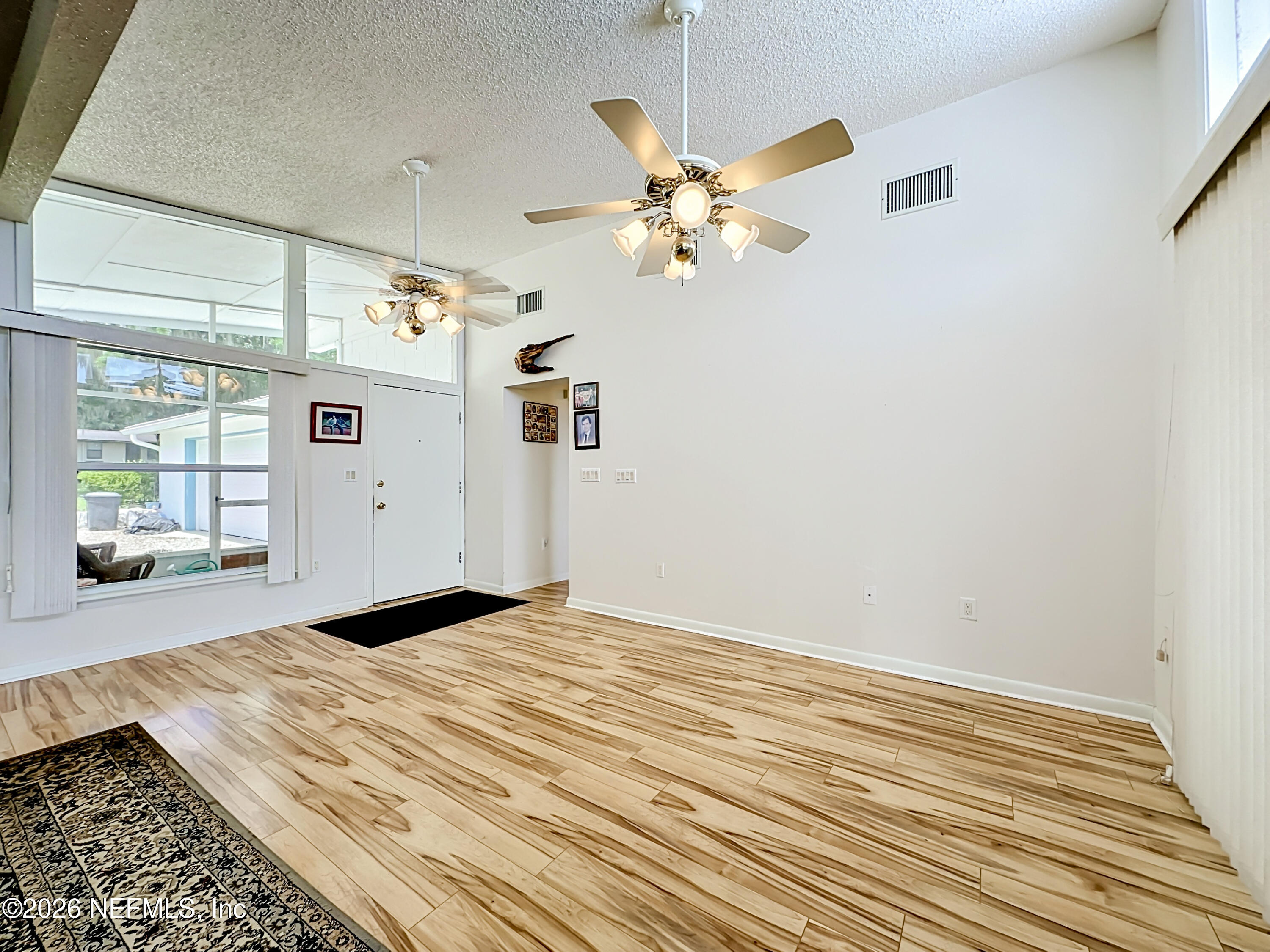 126 Pique Road Crescent City, FL 32112 - Photo 12 of 59 a view of a livingroom with wooden floor and a ceiling fan