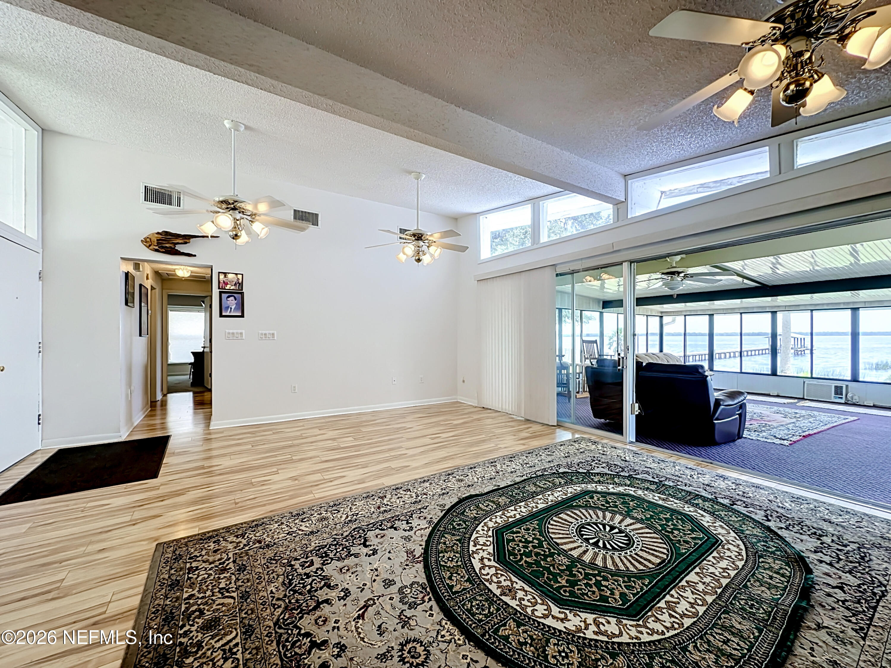 126 Pique Road Crescent City, FL 32112 - Photo 13 of 59 a view of a livingroom with wooden floor and a kitchen
