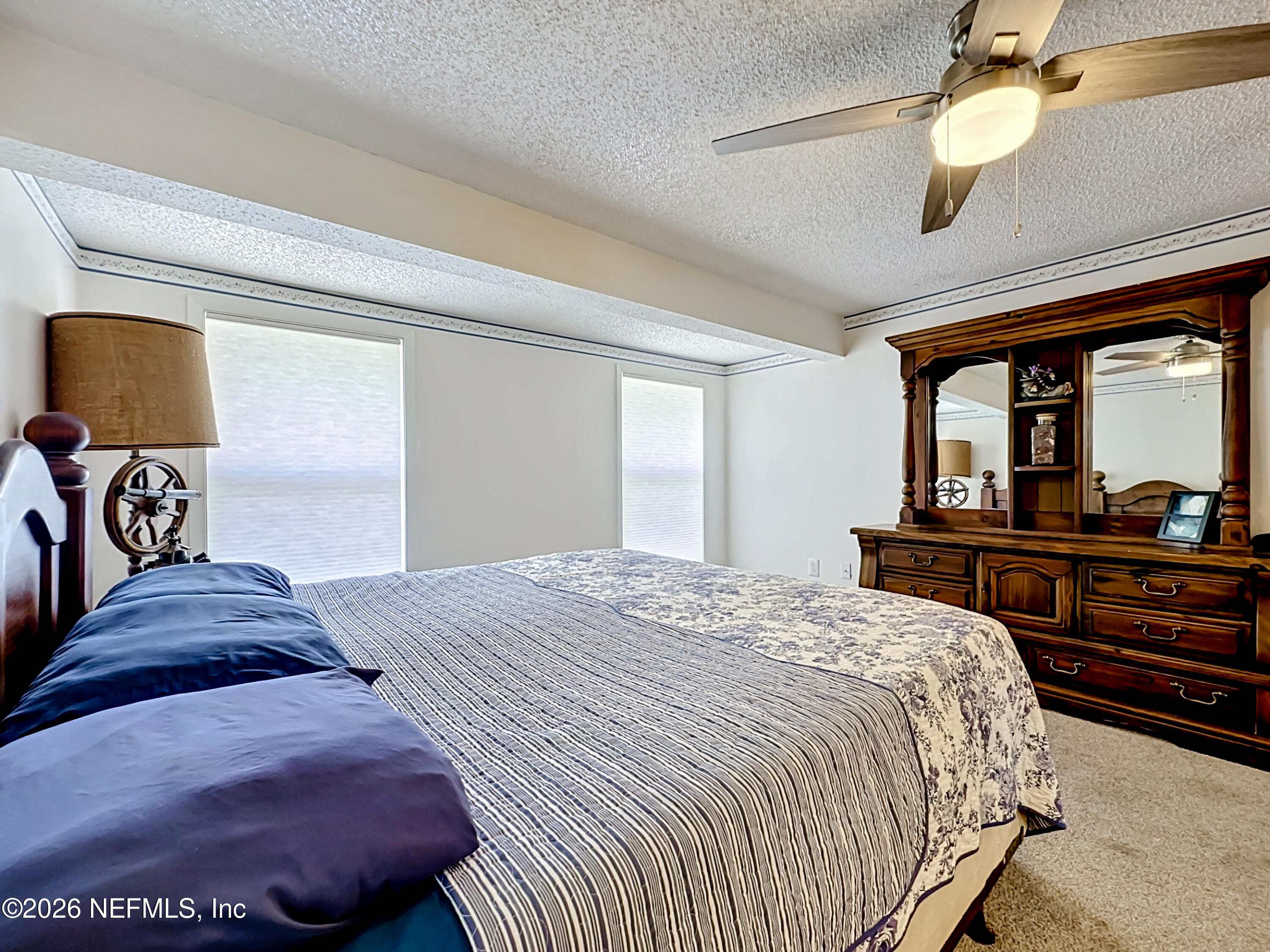 126 Pique Road Crescent City, FL 32112 - Photo 22 of 59 a bedroom with a bed and a large mirror on the dresser
