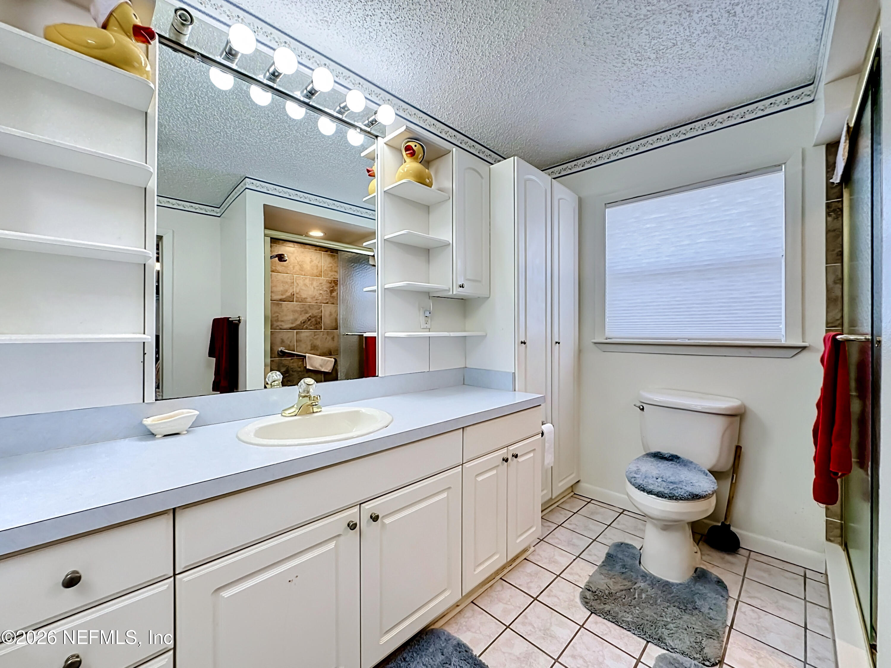 126 Pique Road Crescent City, FL 32112 - Photo 26 of 59 a bathroom with a granite countertop toilet sink and mirror