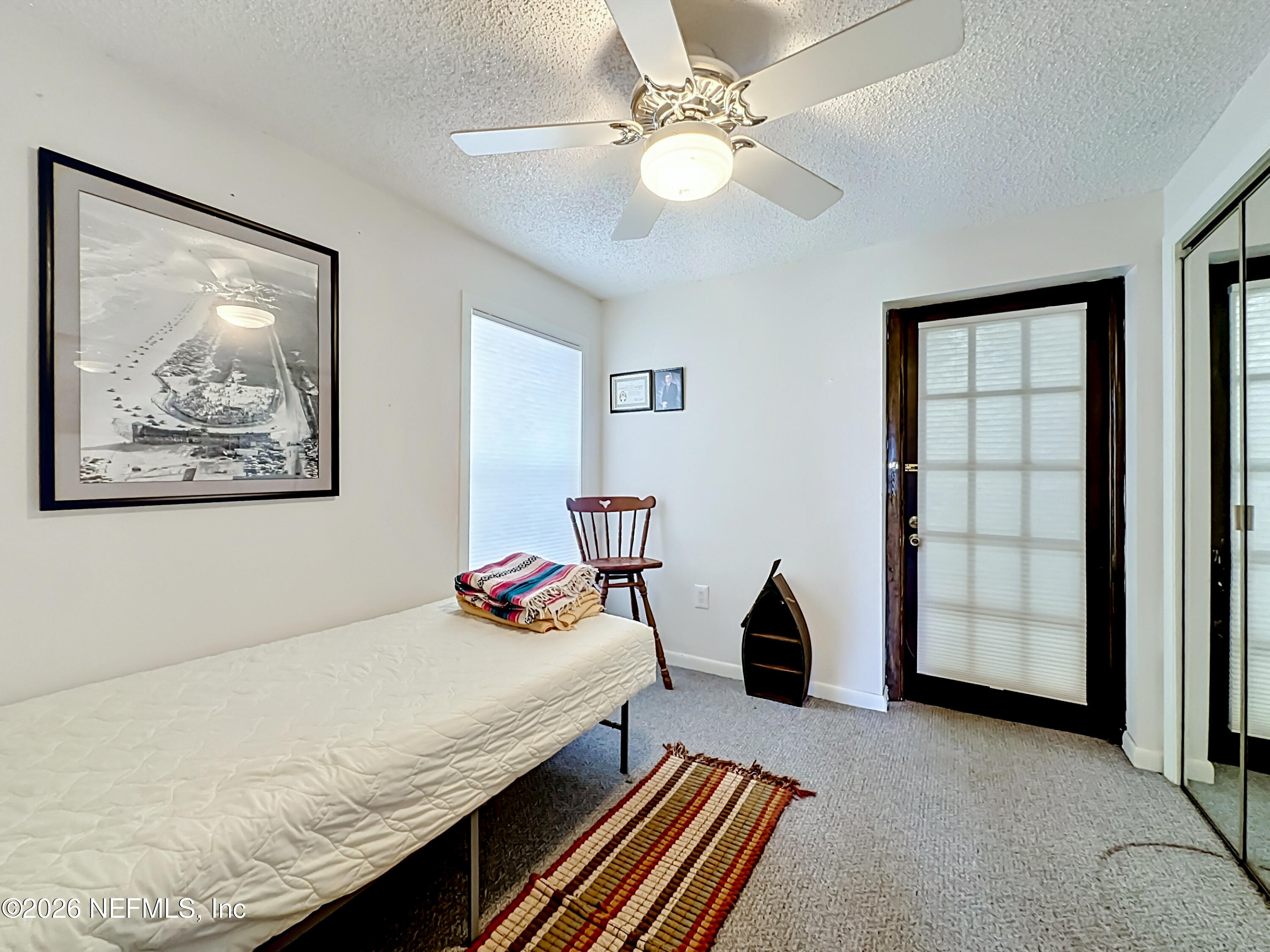 126 Pique Road Crescent City, FL 32112 - Photo 30 of 59 a bedroom with a bed and a chandelier