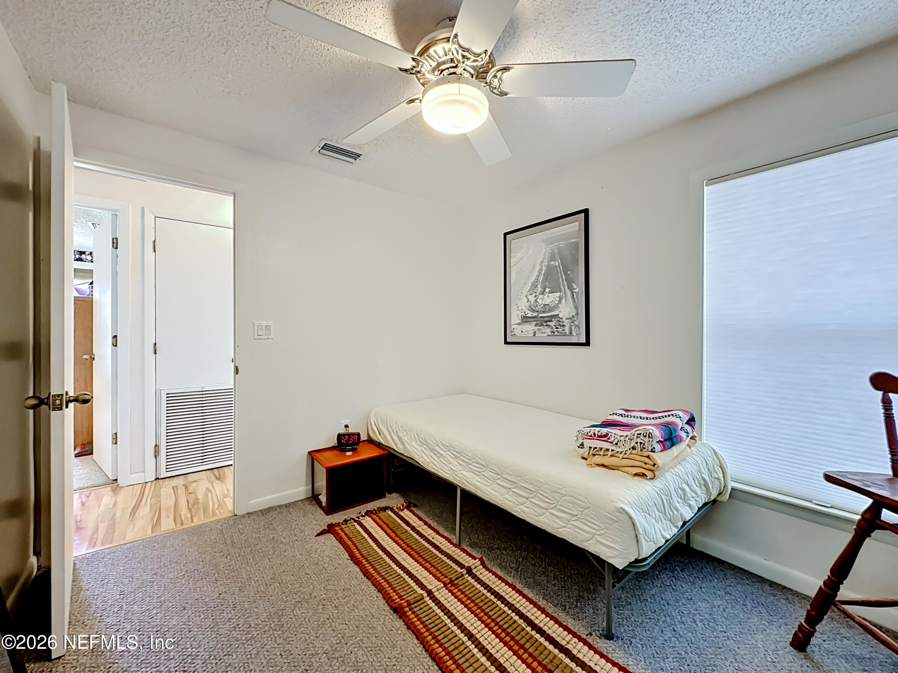 126 Pique Road Crescent City, FL 32112 - Photo 31 of 59 a bedroom with a bed and a chandelier