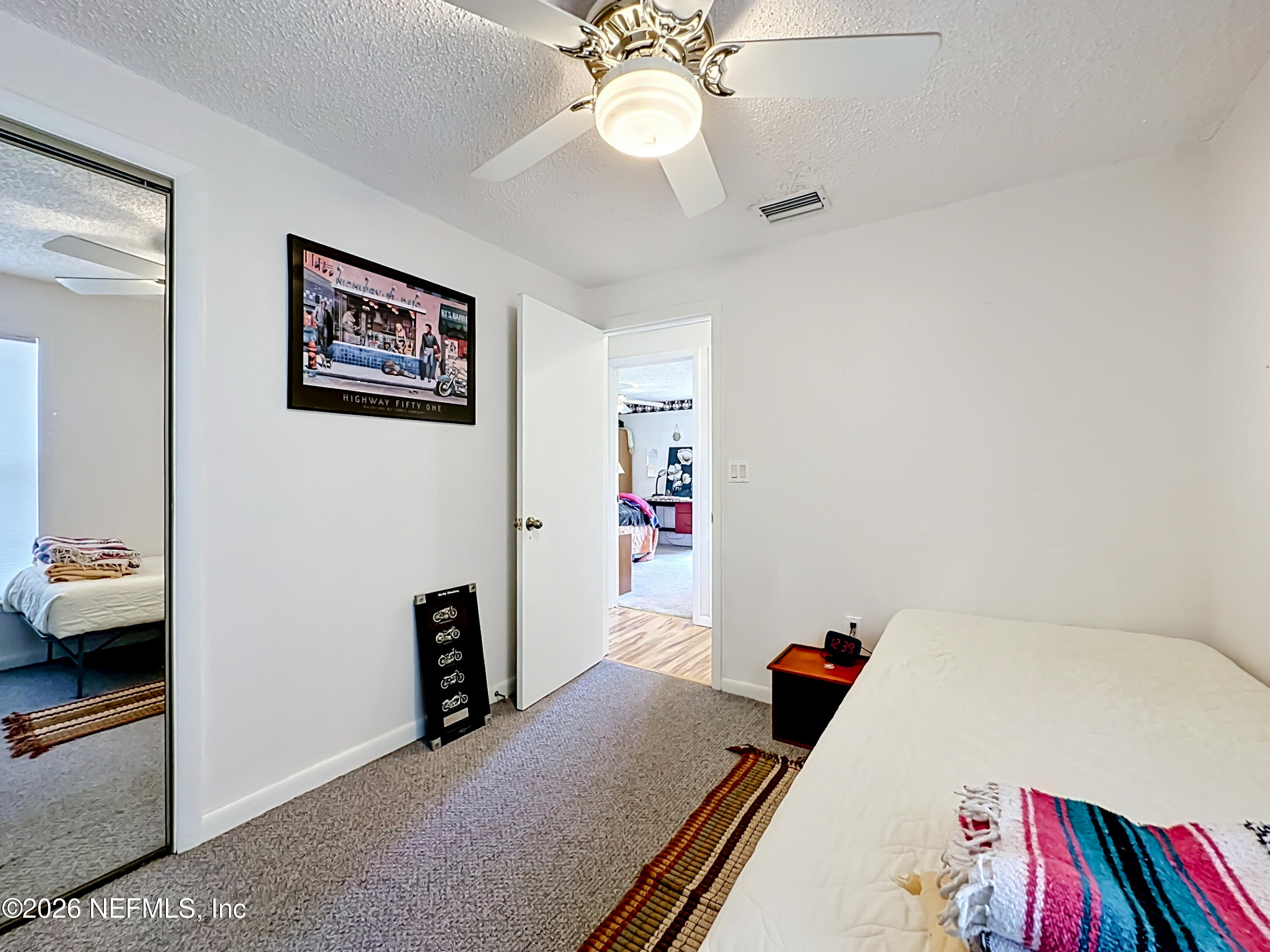 126 Pique Road Crescent City, FL 32112 - Photo 32 of 59 a bed room with a bed and a chandelier