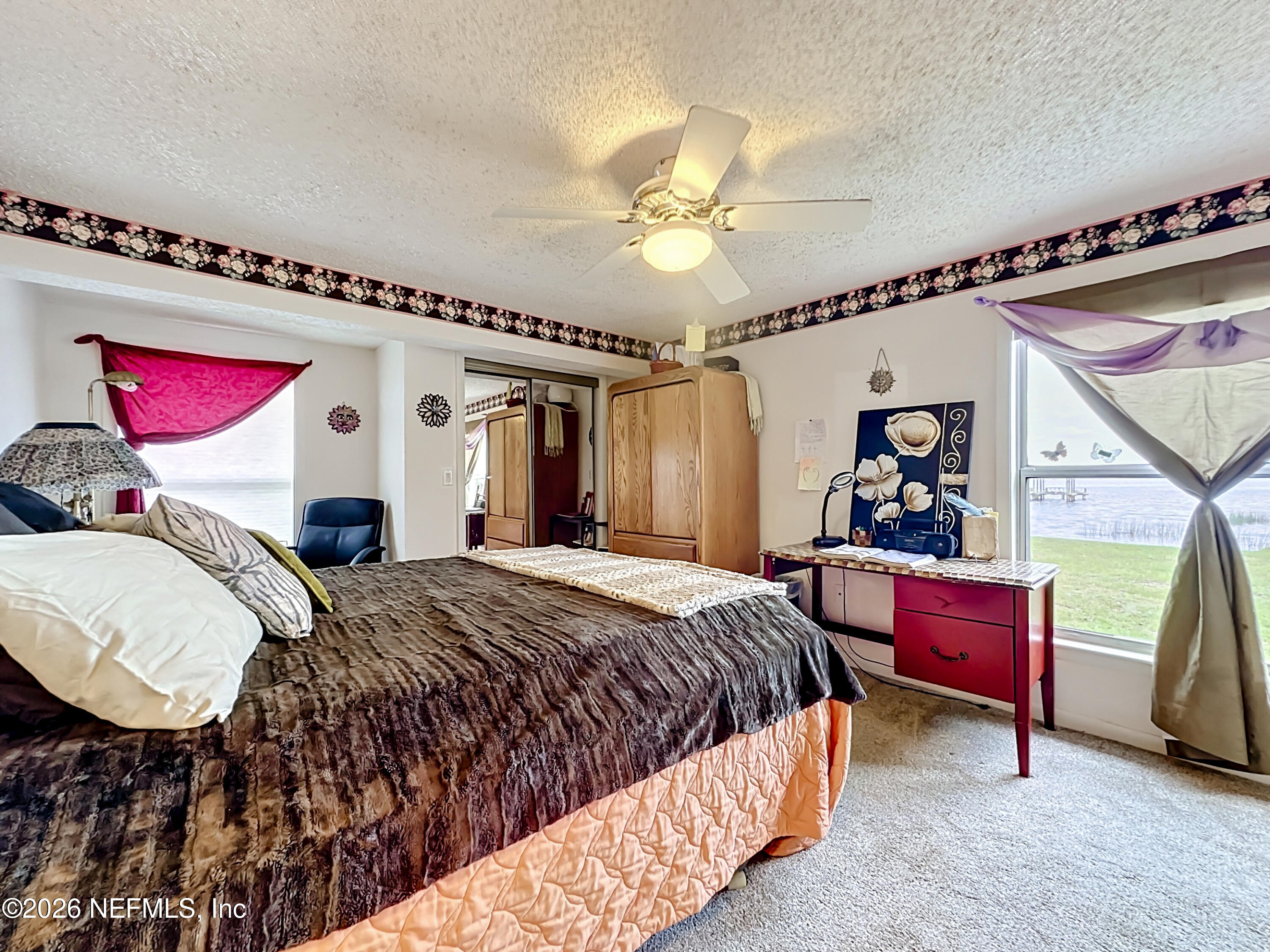126 Pique Road Crescent City, FL 32112 - Photo 33 of 59 a bedroom with a bed and a chandelier
