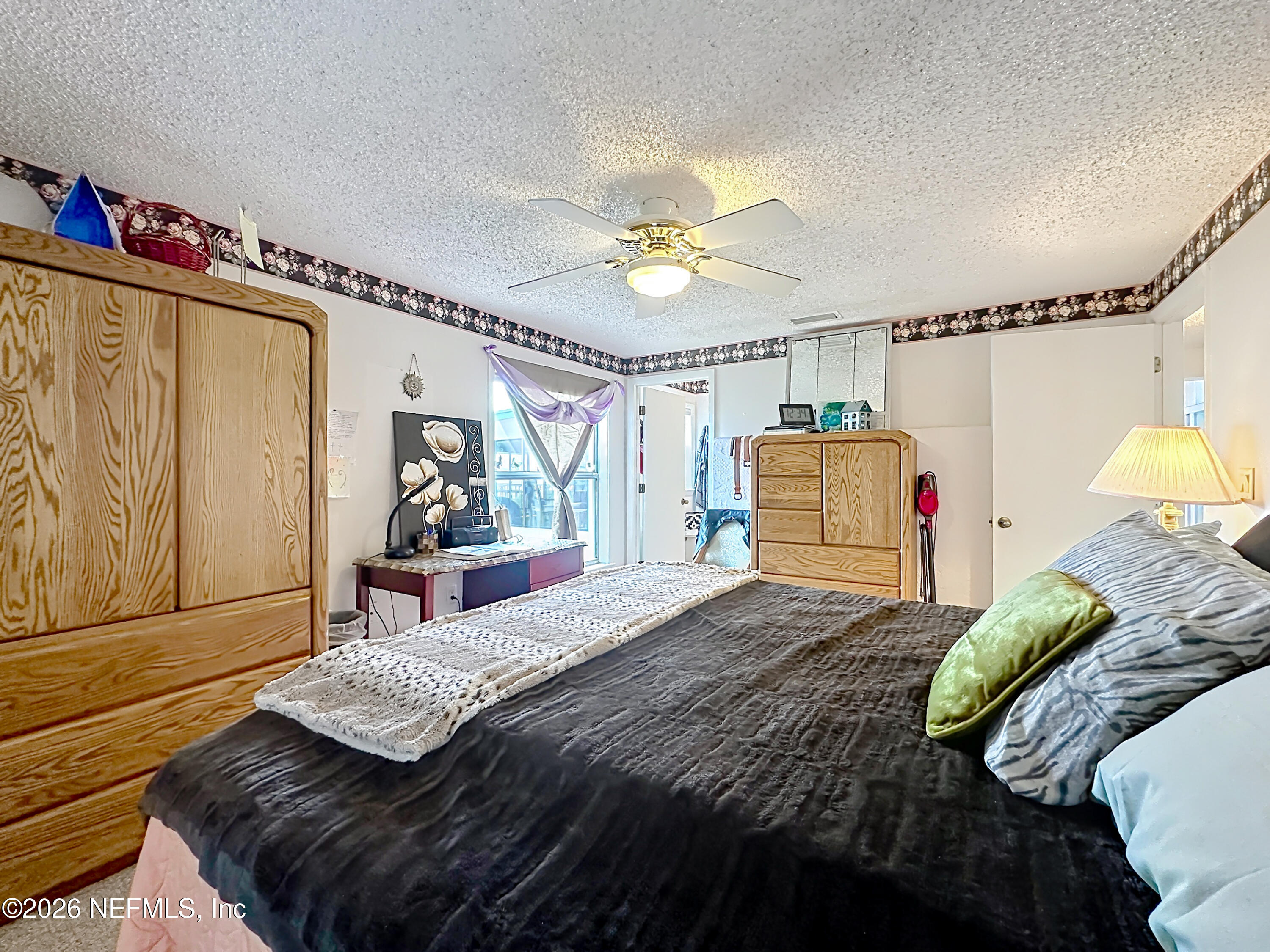 126 Pique Road Crescent City, FL 32112 - Photo 35 of 59 a bedroom with a bed and a chandelier