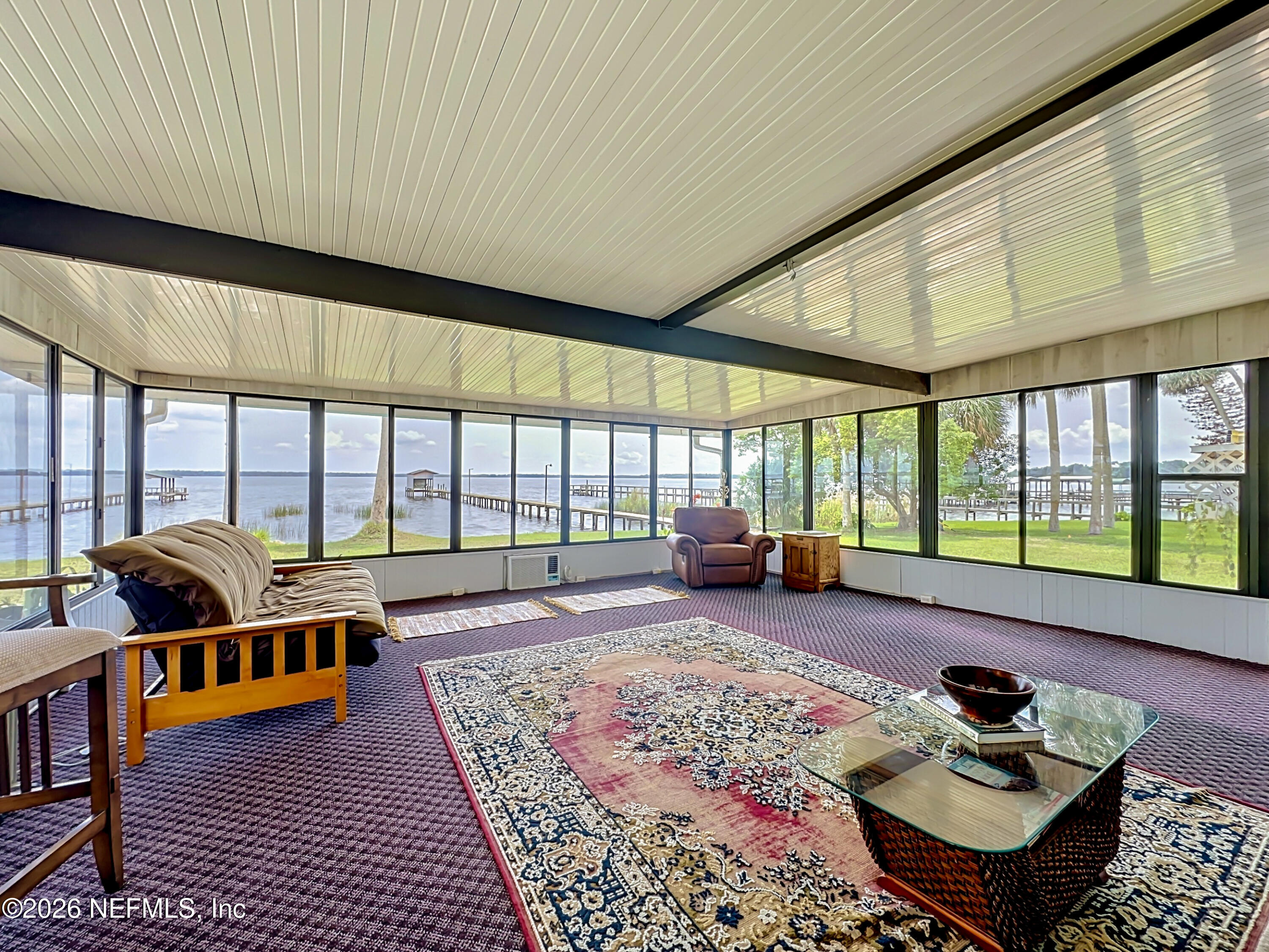 126 Pique Road Crescent City, FL 32112 - Photo 41 of 59 a living room with furniture and a floor to ceiling window