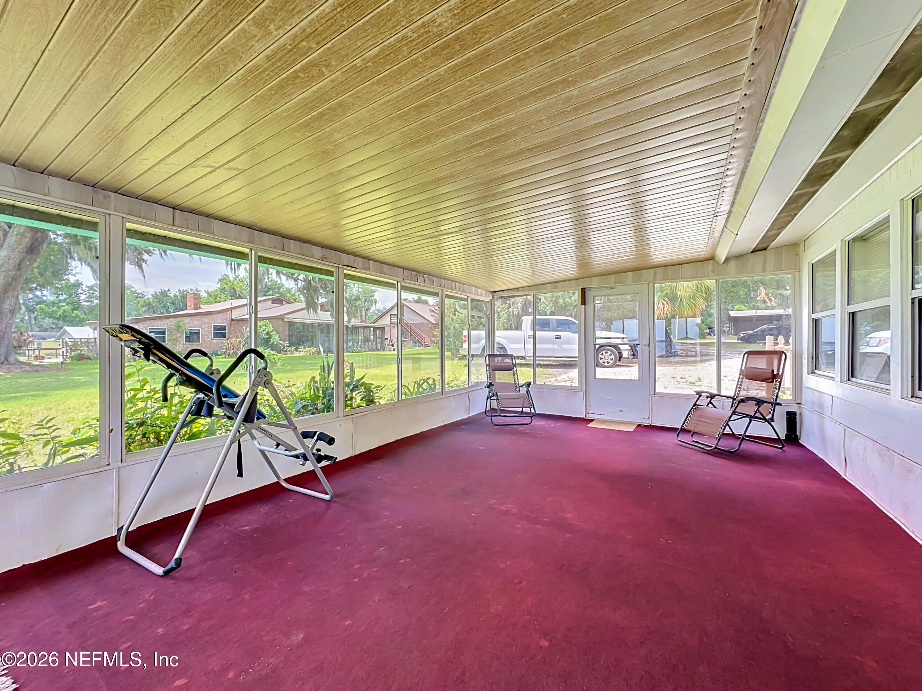 126 Pique Road Crescent City, FL 32112 - Photo 42 of 59 a view of a room with gym equipment and floor to ceiling window