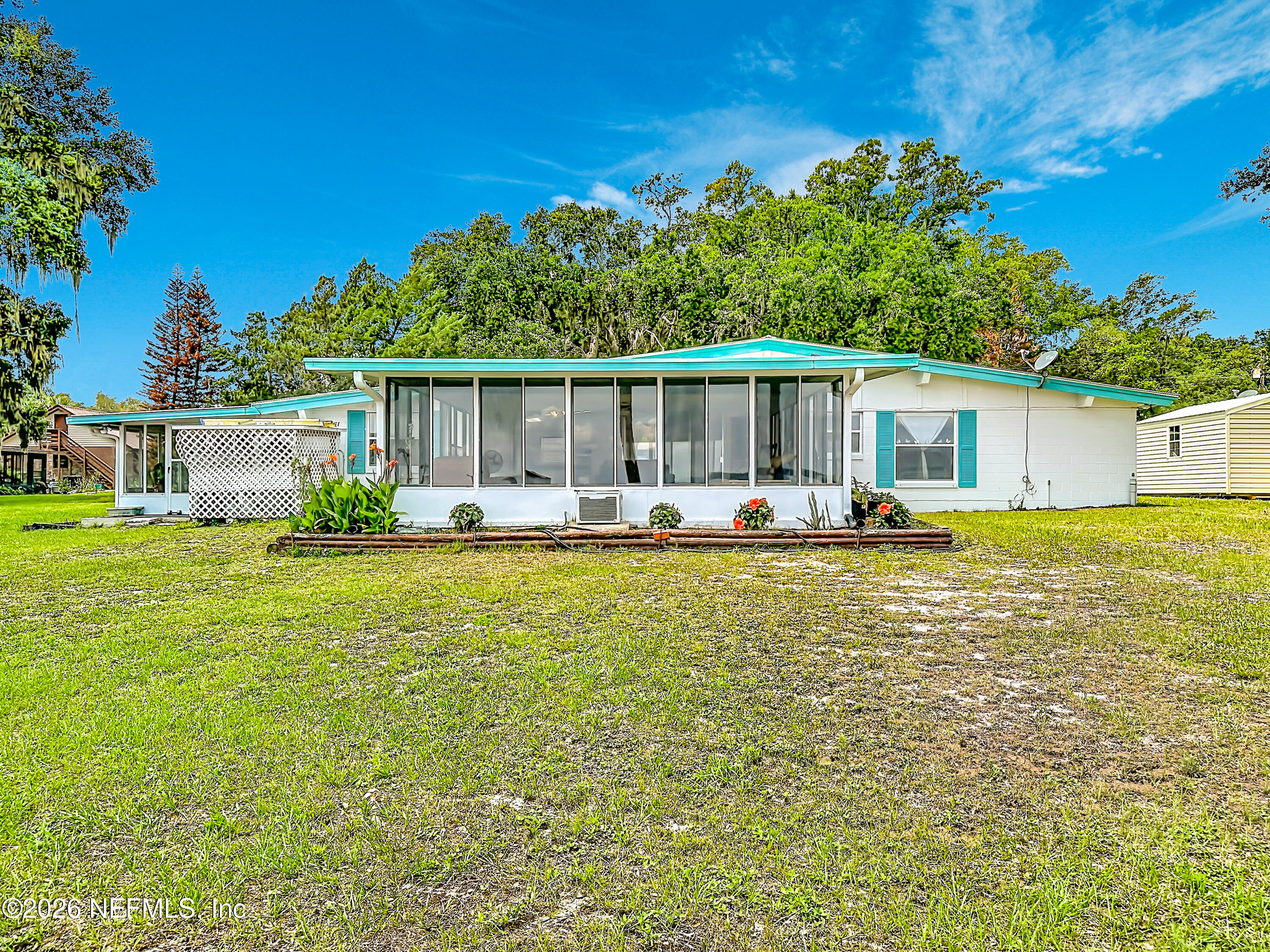 126 Pique Road Crescent City, FL 32112 - Photo 44 of 59 a front view of a house with swimming pool having outdoor seating