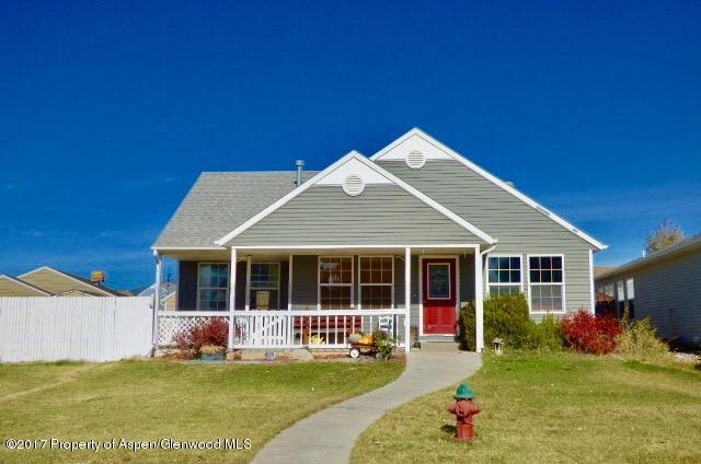 410 Evergreen Drive Rifle, CO 81650 - Photo 1 of 14 a front view of a house with a yard and porch