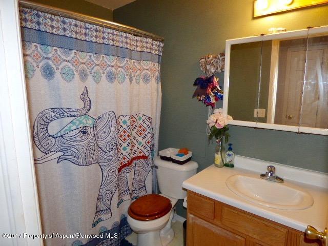 410 Evergreen Drive Rifle, CO 81650 - Photo 11 of 14 a bathroom with a sink toilet and shower