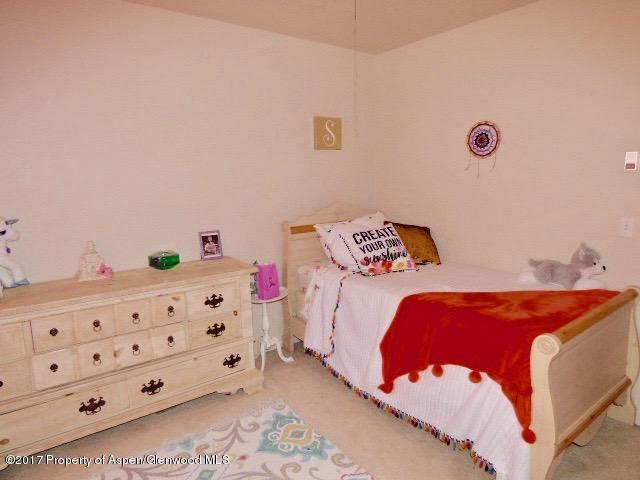 410 Evergreen Drive Rifle, CO 81650 - Photo 12 of 14 a bedroom with a bed and a dresser