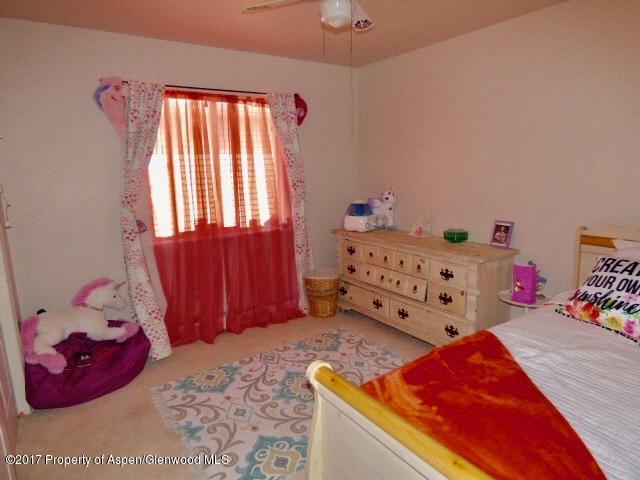 410 Evergreen Drive Rifle, CO 81650 - Photo 13 of 14 a bedroom with a bed and window