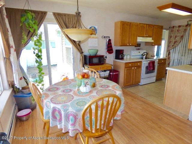 410 Evergreen Drive Rifle, CO 81650 - Photo 2 of 14 a open dining room with furniture window and wooden floor