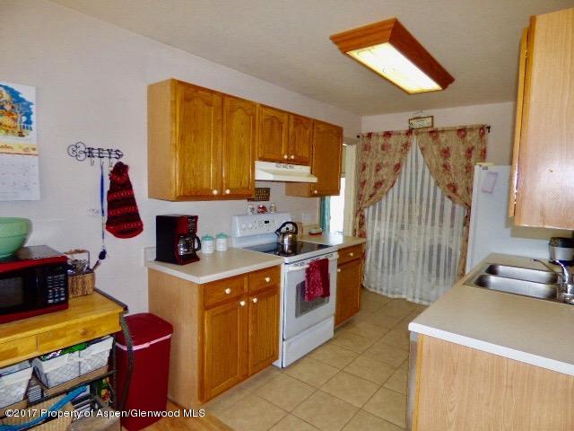 410 Evergreen Drive Rifle, CO 81650 - Photo 3 of 14 a kitchen that has a sink and a stove in it