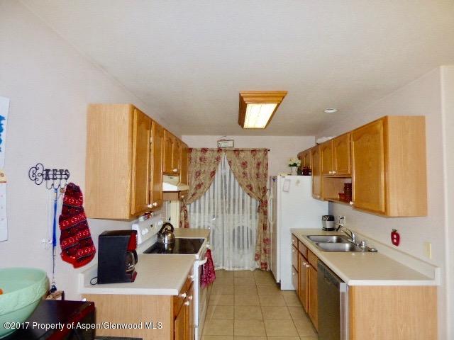 410 Evergreen Drive Rifle, CO 81650 - Photo 4 of 14 a view of a kitchen with a sink and a refrigerator