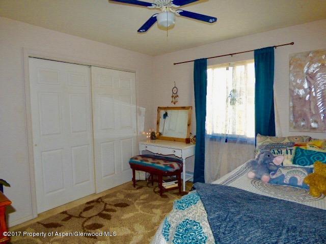 410 Evergreen Drive Rifle, CO 81650 - Photo 10 of 14 a bedroom with furniture and a window