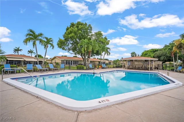 a view of a swimming pool with an outdoor seating