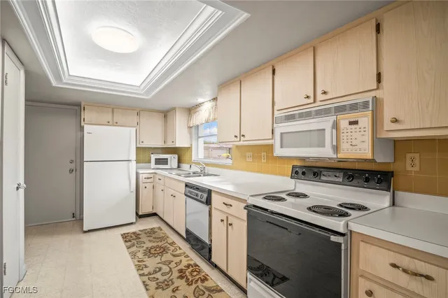 a kitchen with a stove sink and cabinets