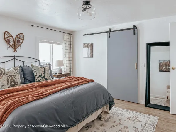 a bedroom with bed and a couch