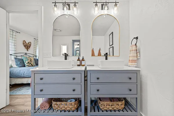 a bathroom with a sink toilet a mirror and shower