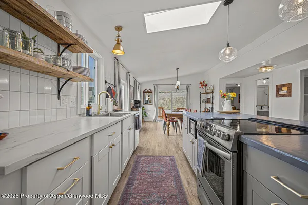 a kitchen with a refrigerator and a sink