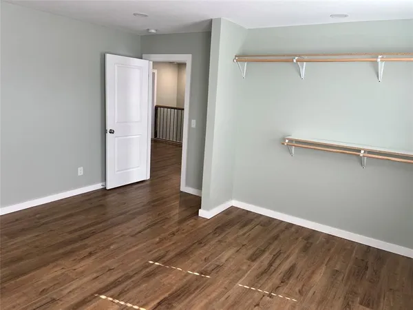a view of a room with wooden floor