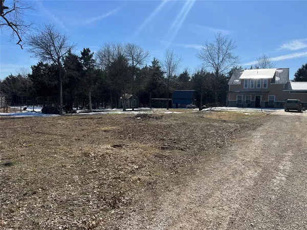 a big yard with road and trees