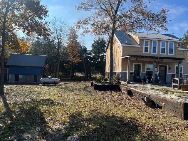 a view of a house with yard and sitting area