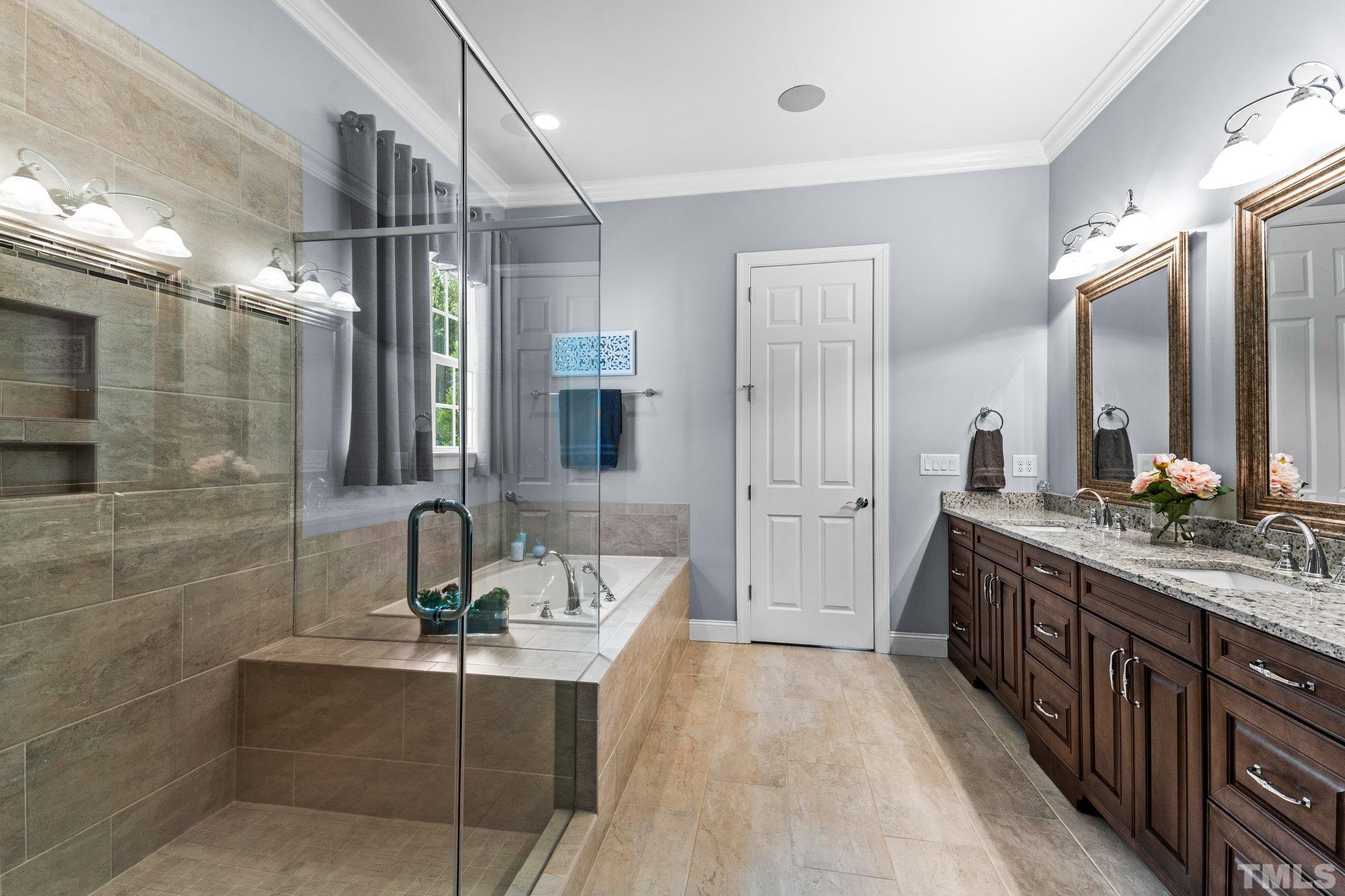 384 Colonial Ridge Drive Pittsboro, NC 27312 - Photo 14 of 47 a spacious bathroom with a double vanity sink a mirror and shower