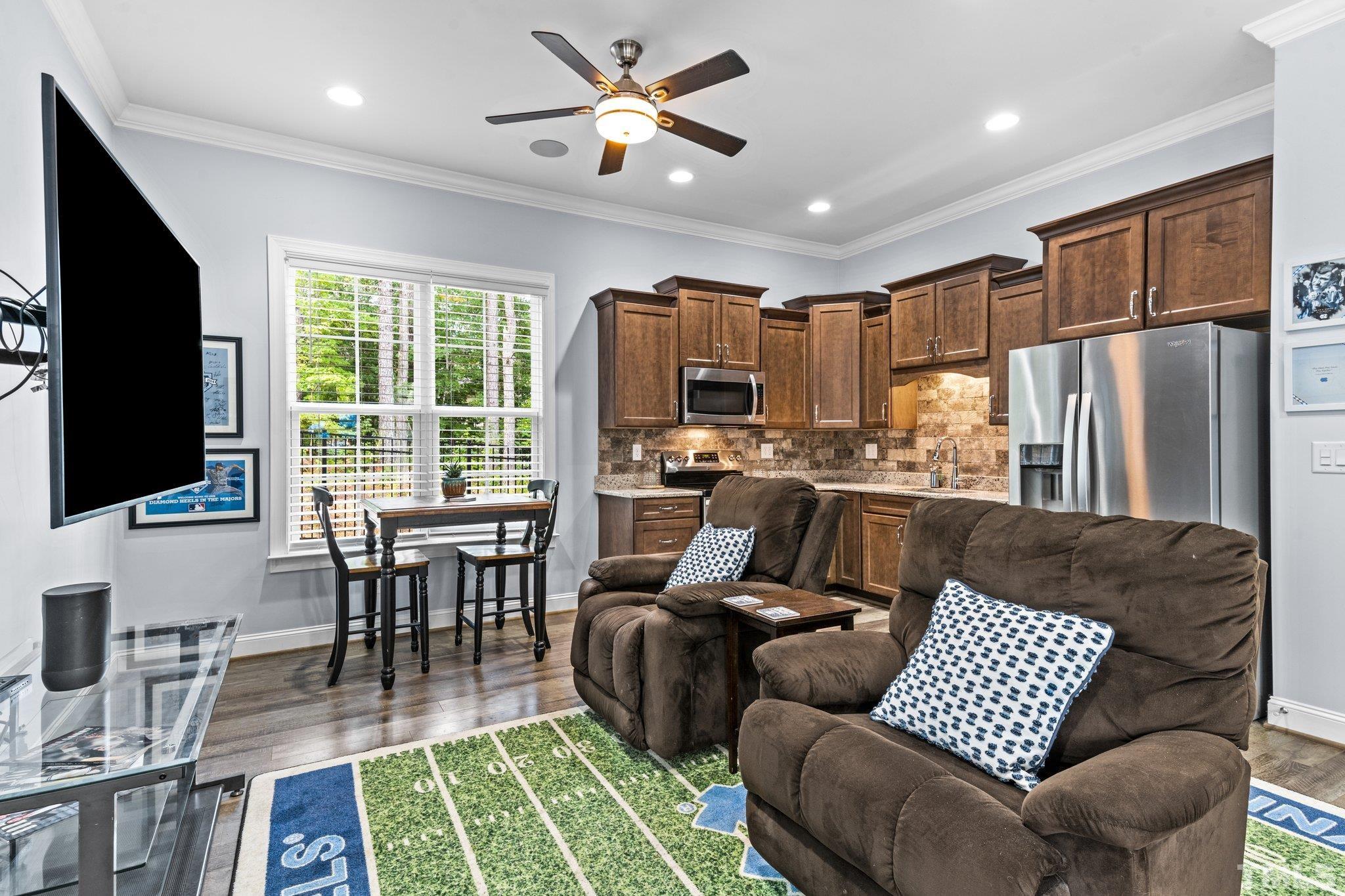 384 Colonial Ridge Drive Pittsboro, NC 27312 - Photo 19 of 47 a living room with furniture fireplace and a flat screen tv