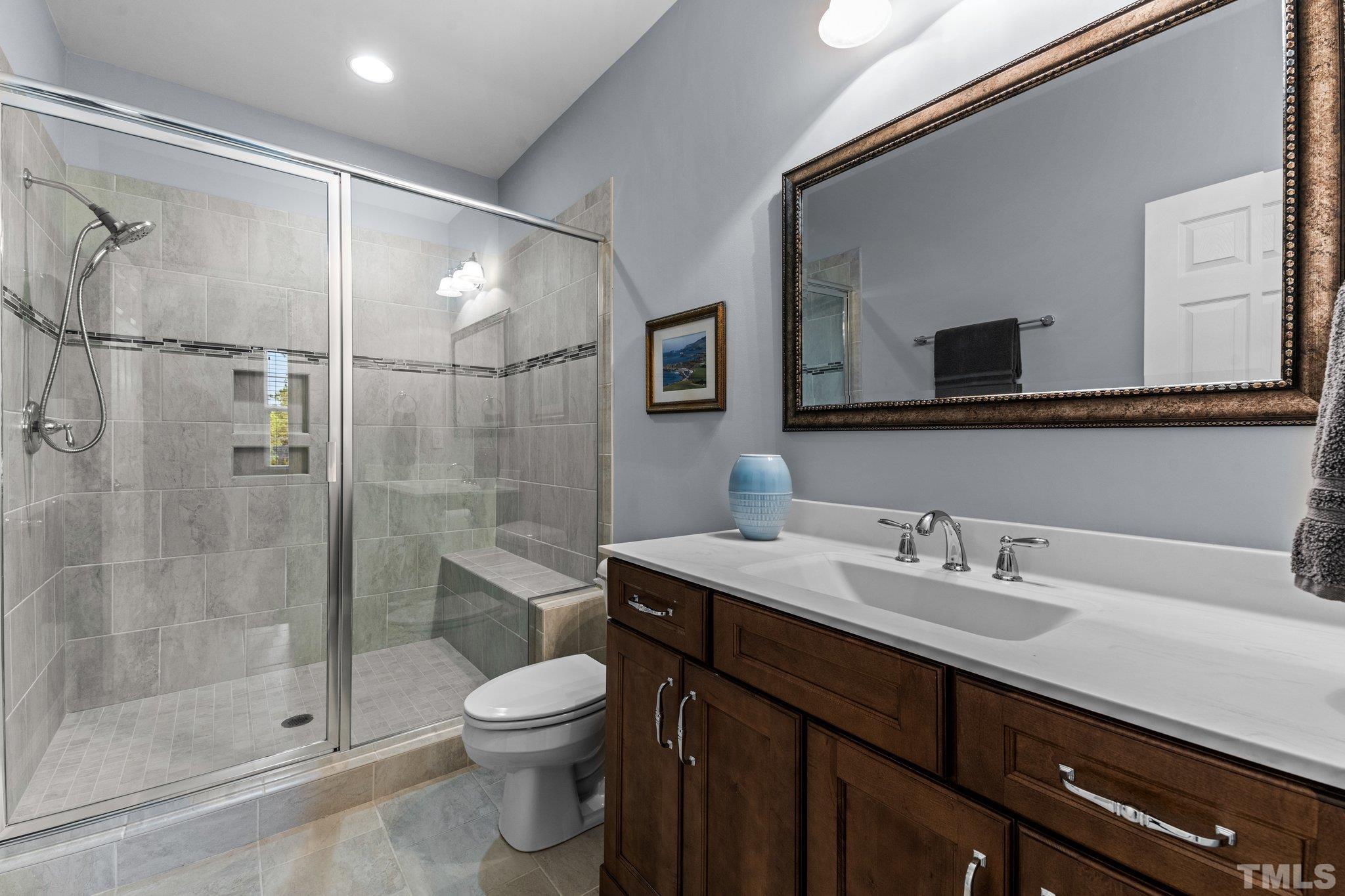 384 Colonial Ridge Drive Pittsboro, NC 27312 - Photo 25 of 47 a bathroom with a sink a toilet and shower