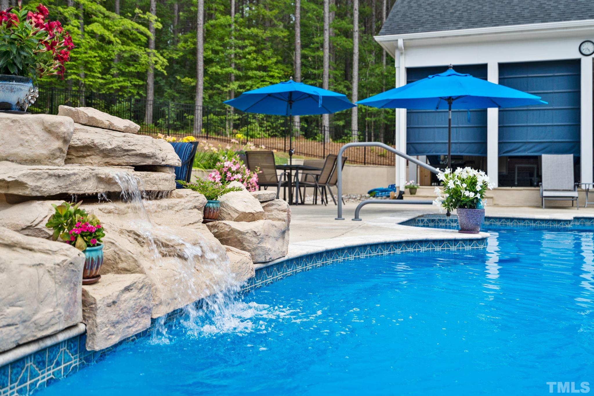 384 Colonial Ridge Drive Pittsboro, NC 27312 - Photo 29 of 47 a view of a table and chairs under an umbrella