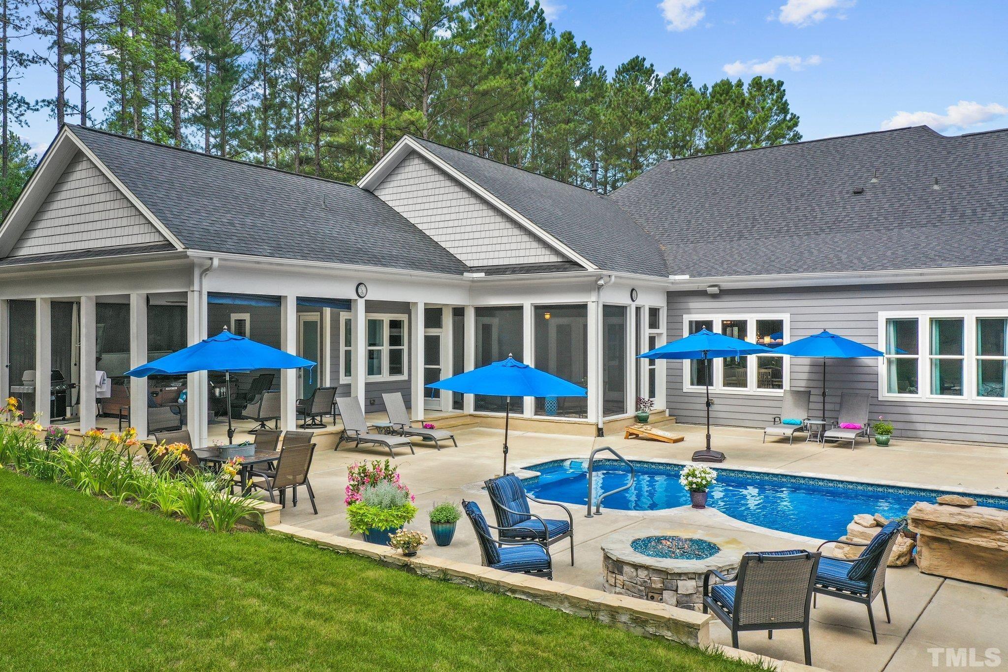 384 Colonial Ridge Drive Pittsboro, NC 27312 - Photo 3 of 47 a swimming pool with outdoor seating and yard