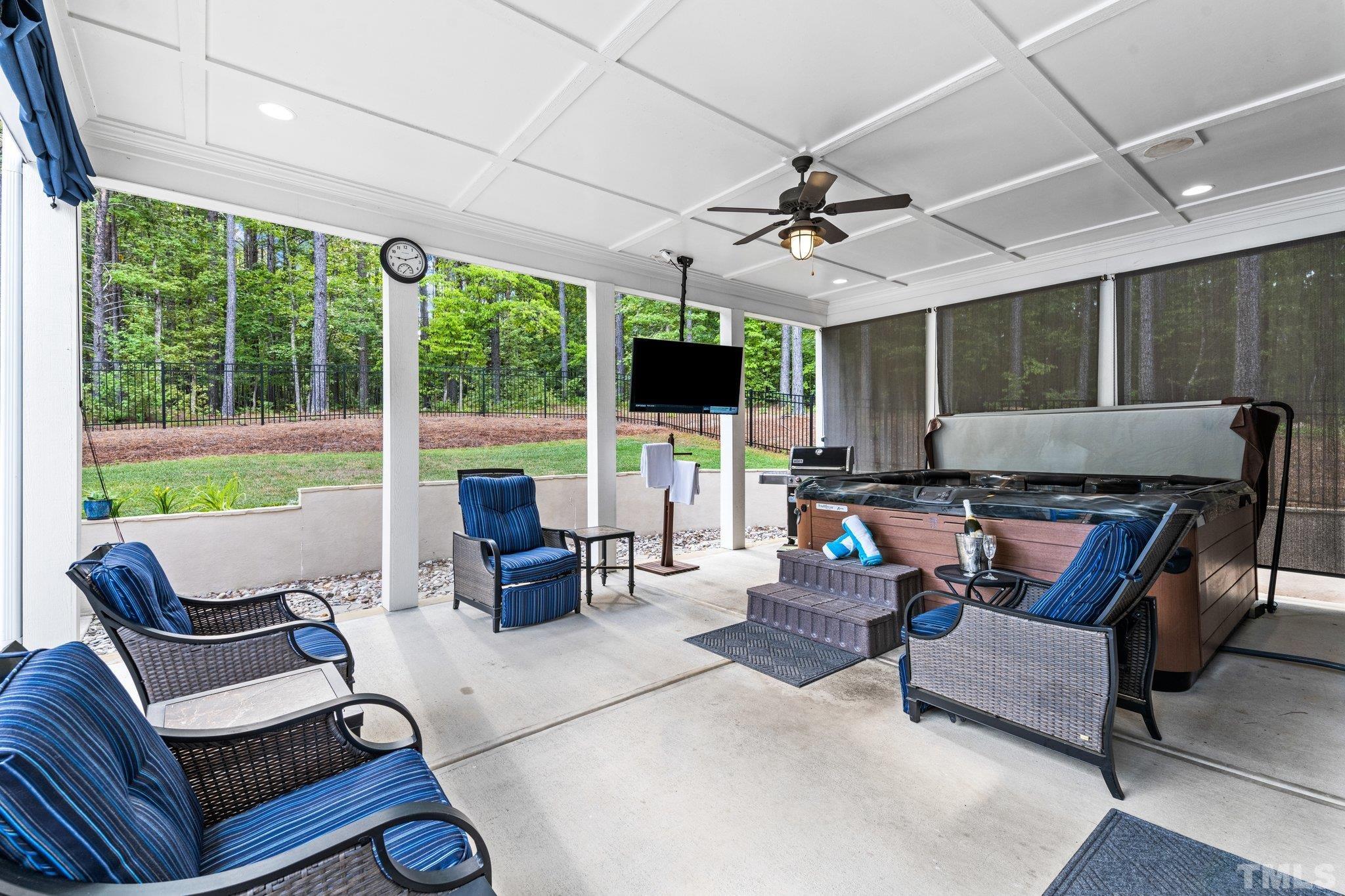 384 Colonial Ridge Drive Pittsboro, NC 27312 - Photo 35 of 47 a living room with patio fireplace furniture and a flat screen tv