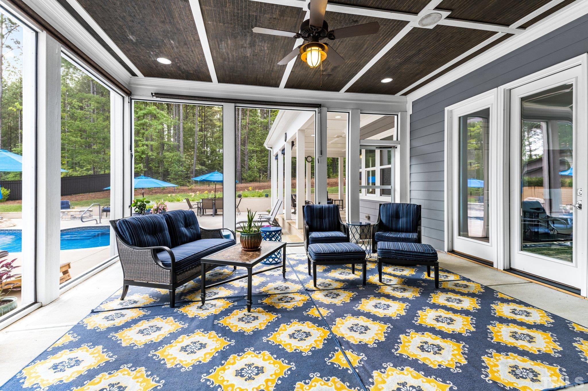 384 Colonial Ridge Drive Pittsboro, NC 27312 - Photo 37 of 47 a living room with furniture and a floor to ceiling window