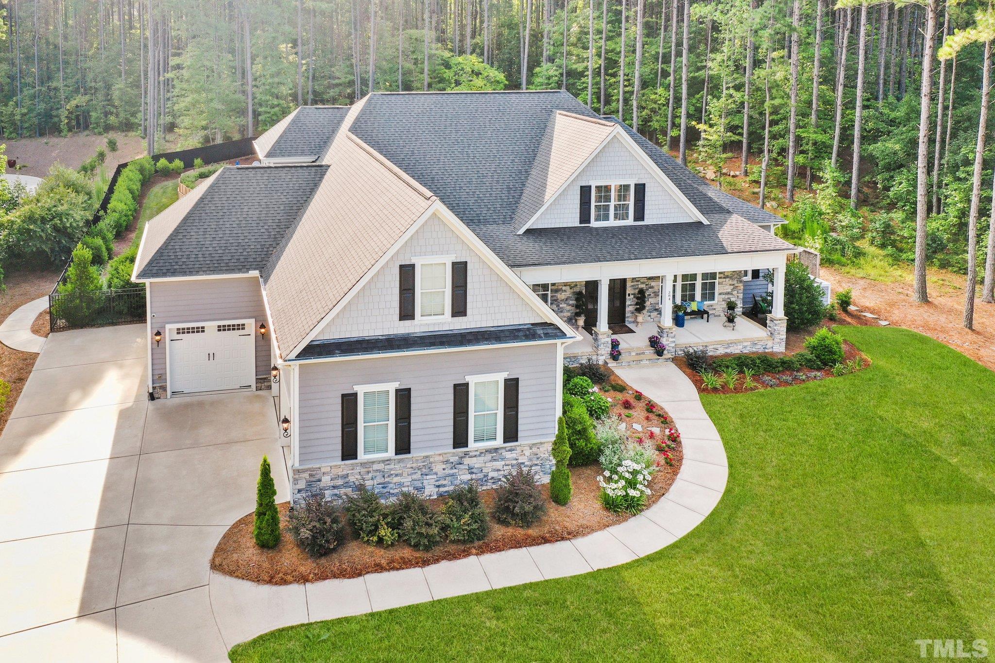 384 Colonial Ridge Drive Pittsboro, NC 27312 - Photo 40 of 47 a front view of a house with garden