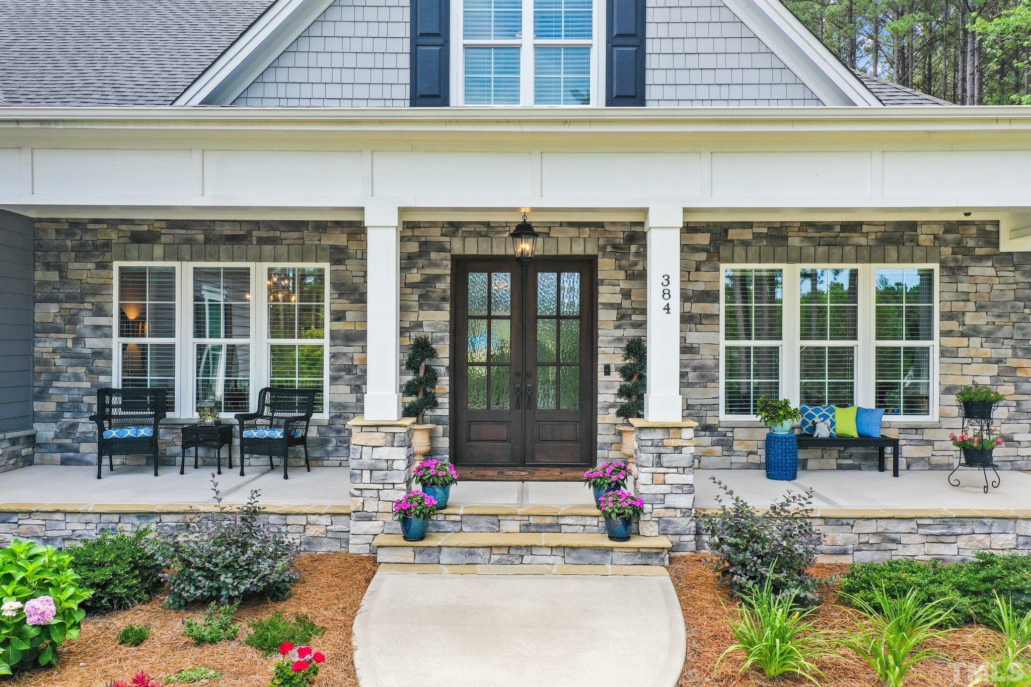 384 Colonial Ridge Drive Pittsboro, NC 27312 - Photo 4 of 47 a view of a building with sitting area and garden