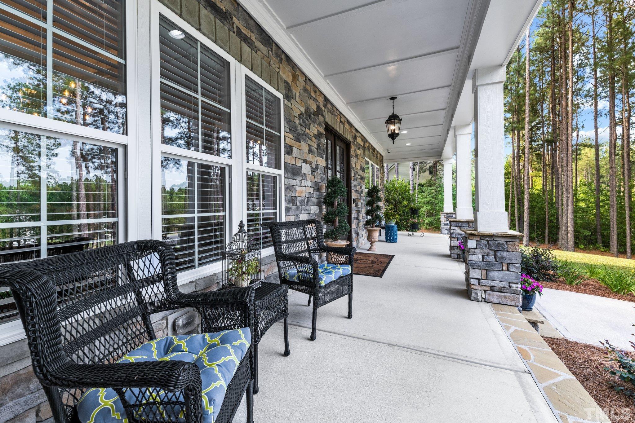 384 Colonial Ridge Drive Pittsboro, NC 27312 - Photo 41 of 47 a view of a patio with couches table and chairs and potted plants
