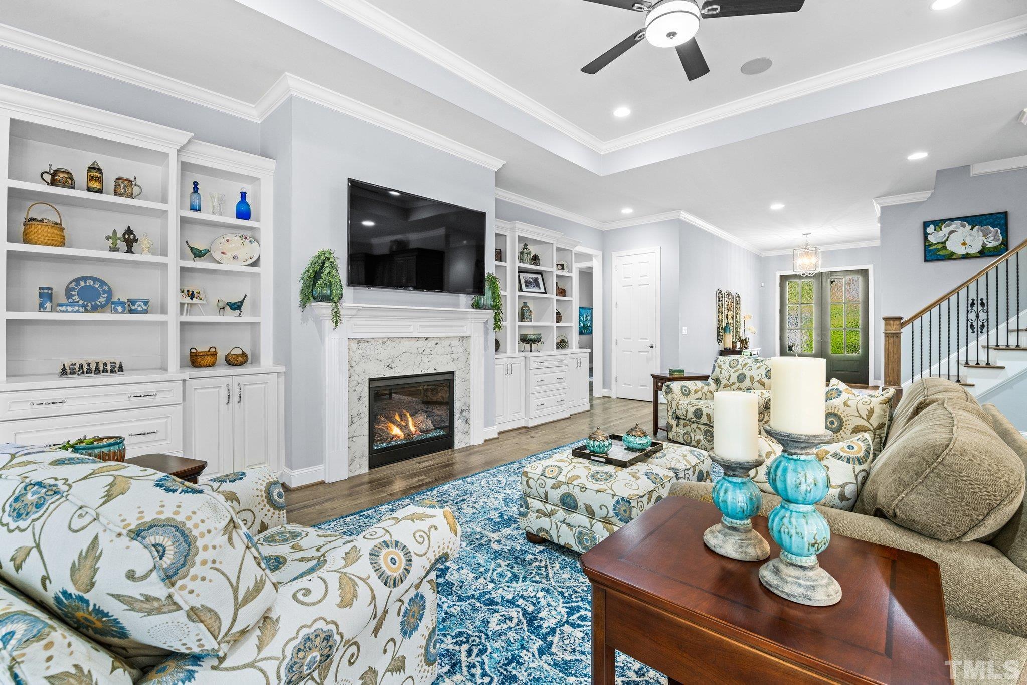 384 Colonial Ridge Drive Pittsboro, NC 27312 - Photo 7 of 47 a living room with furniture a flat screen tv and a fireplace