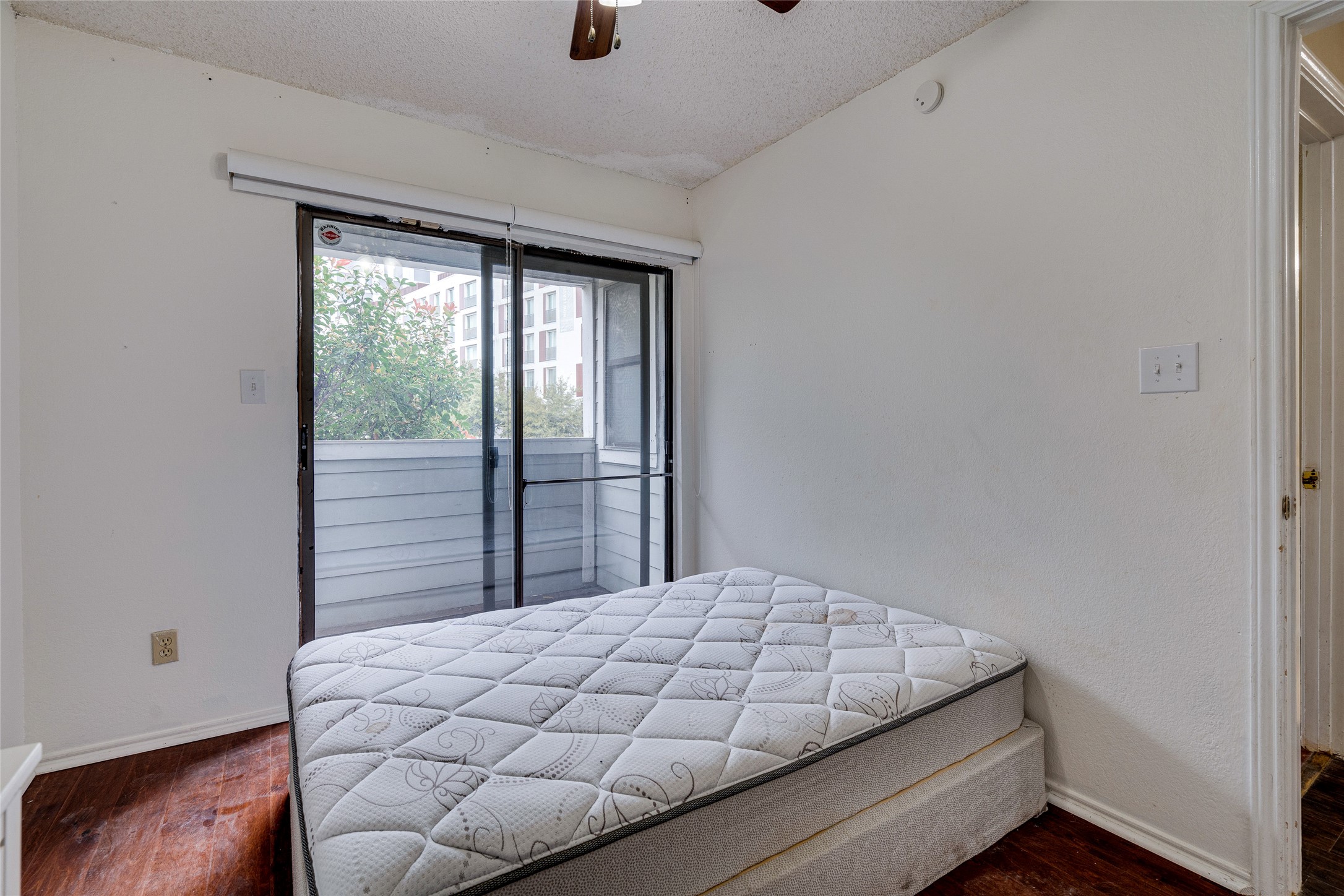 1808 Rio Grande Street, Unit 6 Austin, TX 78701 - Photo 16 of 29 Bedroom with access to exterior, dark wood-style flooring, and ceiling fan