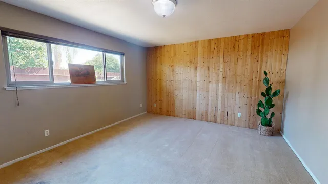 an empty room with windows and flower in a room
