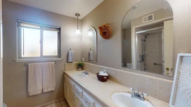 a bathroom with a granite countertop sink and a mirror