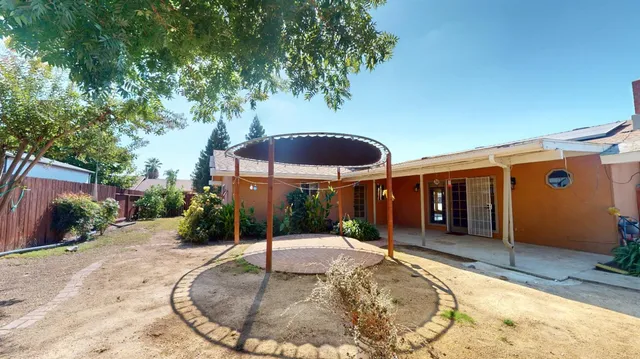 a view of a house with backyard porch and sitting area