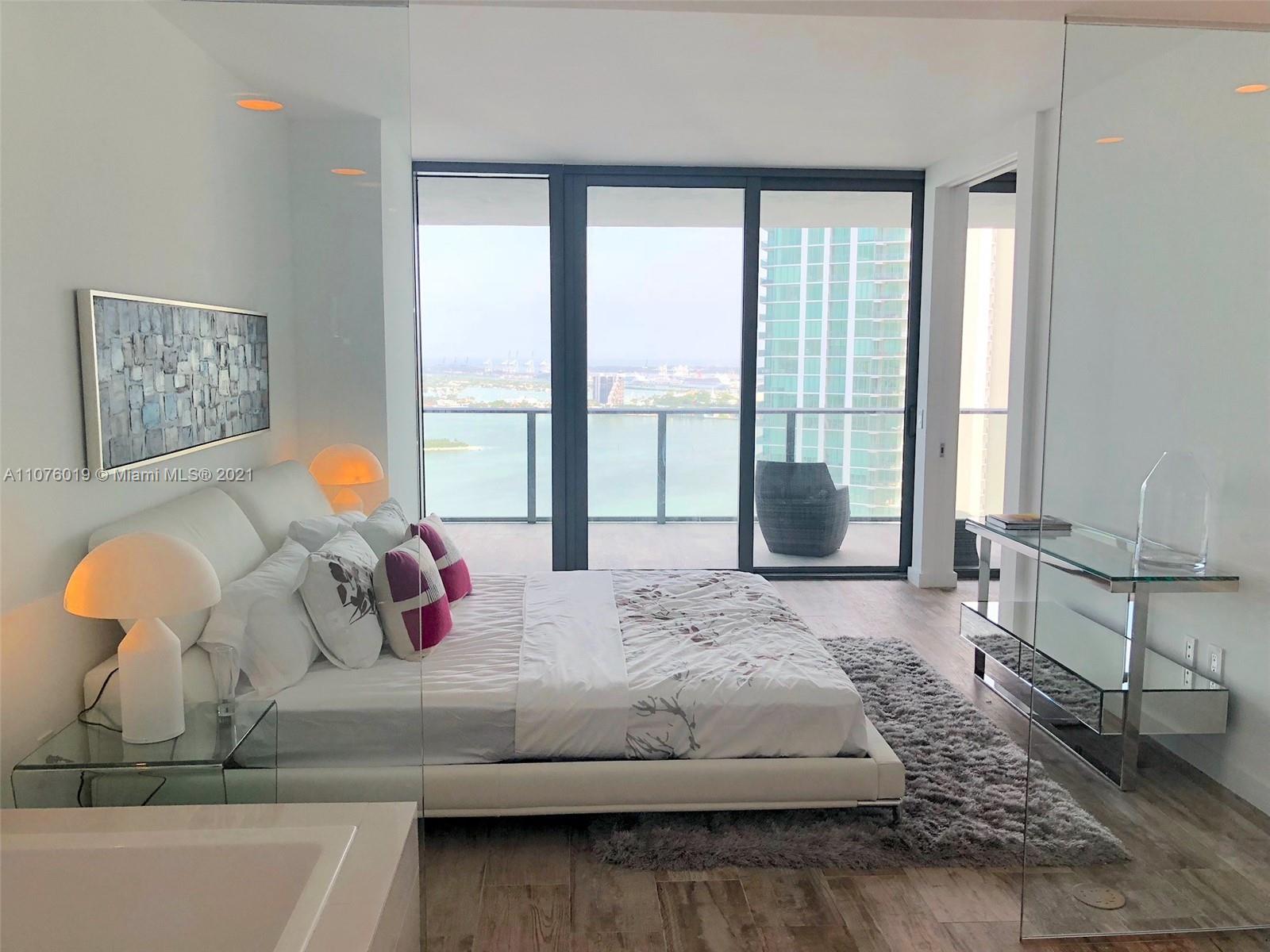 650 Northeast 32nd Street, Unit 4103 Miami, FL 33137 - Photo 16 of 44 a bedroom with a bed and large windows