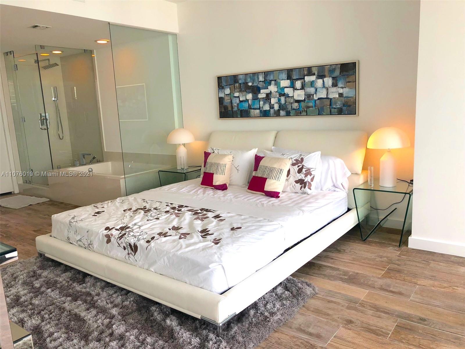 650 Northeast 32nd Street, Unit 4103 Miami, FL 33137 - Photo 17 of 44 a bedroom with a bed and a window