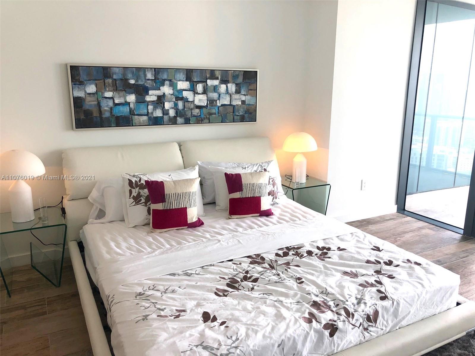 650 Northeast 32nd Street, Unit 4103 Miami, FL 33137 - Photo 18 of 44 a bedroom with a bed and a window