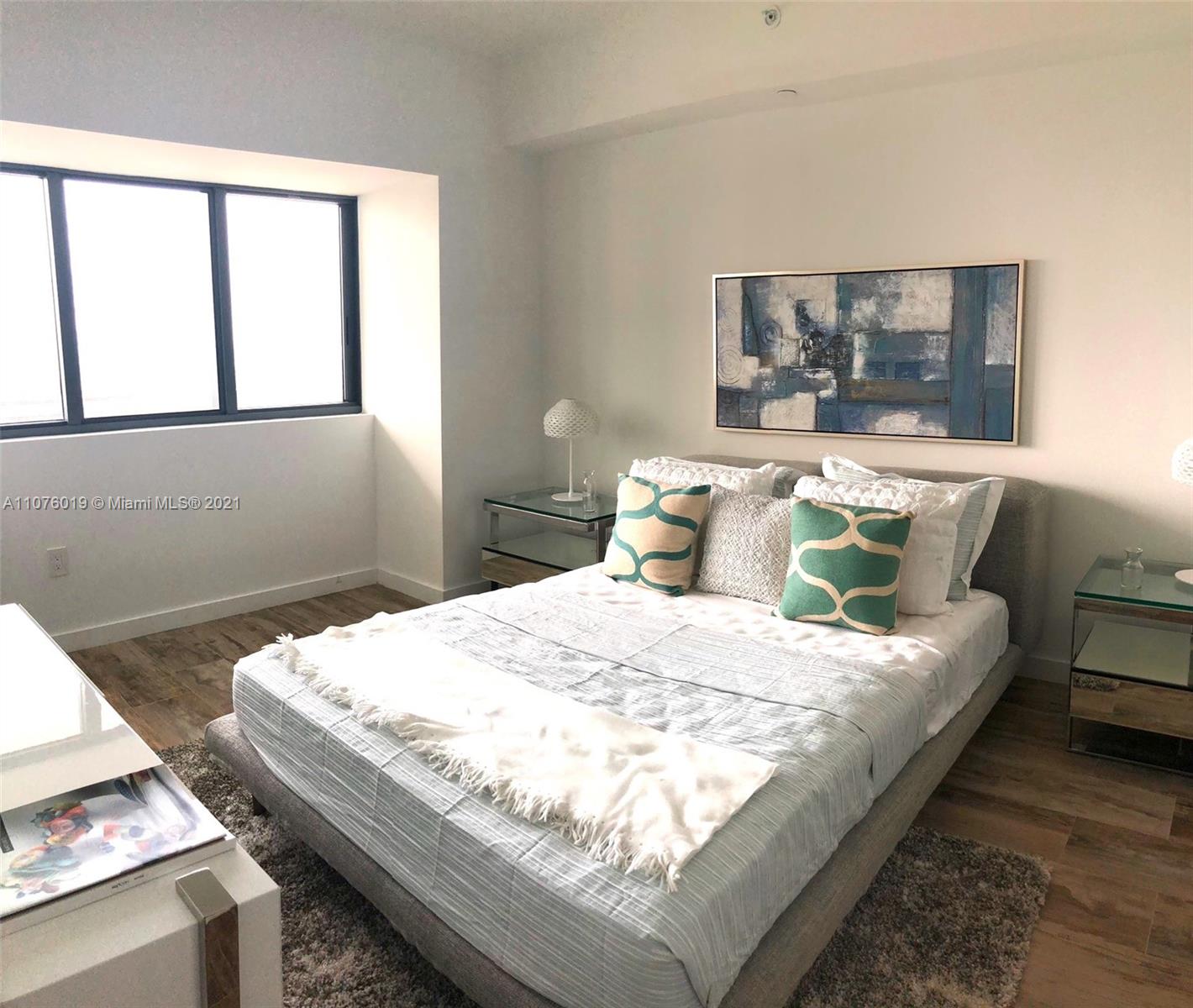 650 Northeast 32nd Street, Unit 4103 Miami, FL 33137 - Photo 21 of 44 a bedroom with bed and window