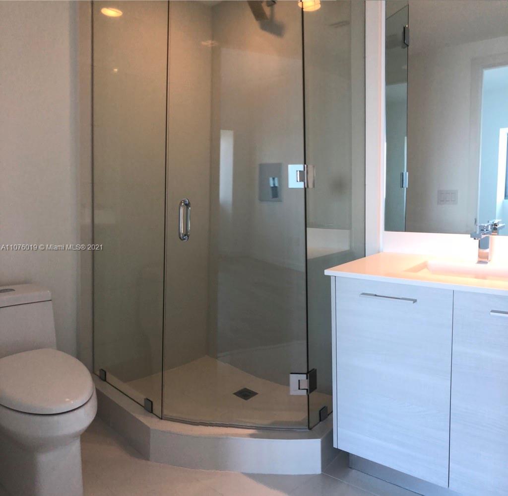 650 Northeast 32nd Street, Unit 4103 Miami, FL 33137 - Photo 23 of 44 a bathroom with a shower a toilet and a sink